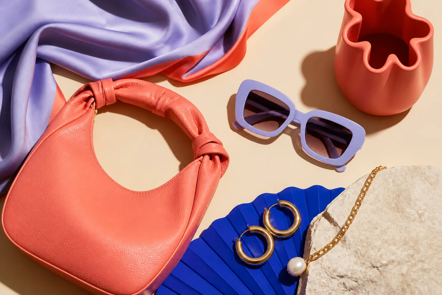 A colourful editorial arrangement of fashion accessories.